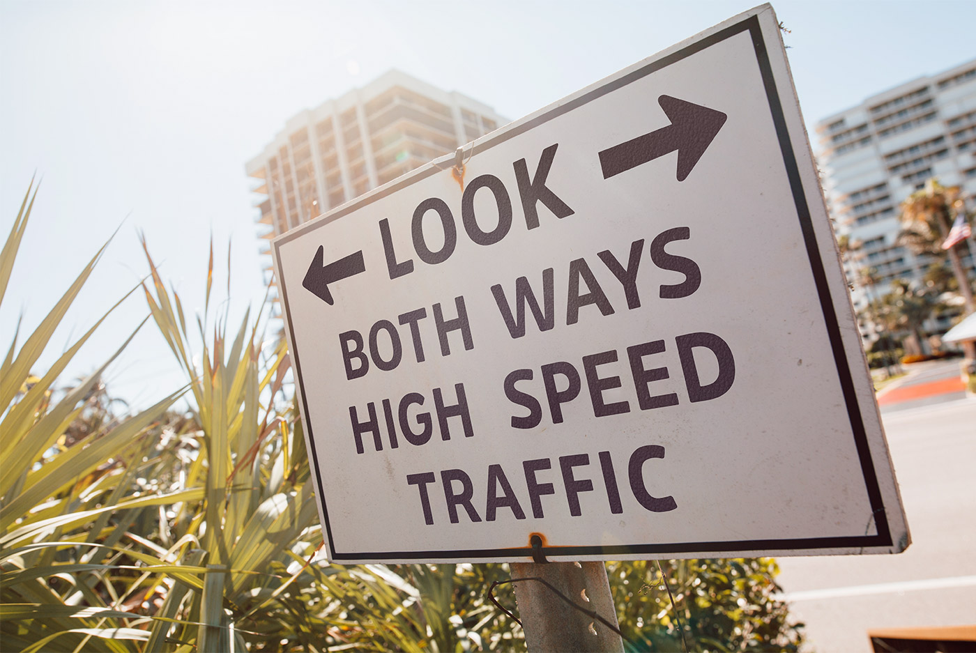 Road sign example: "Look both ways. High speed traffic."