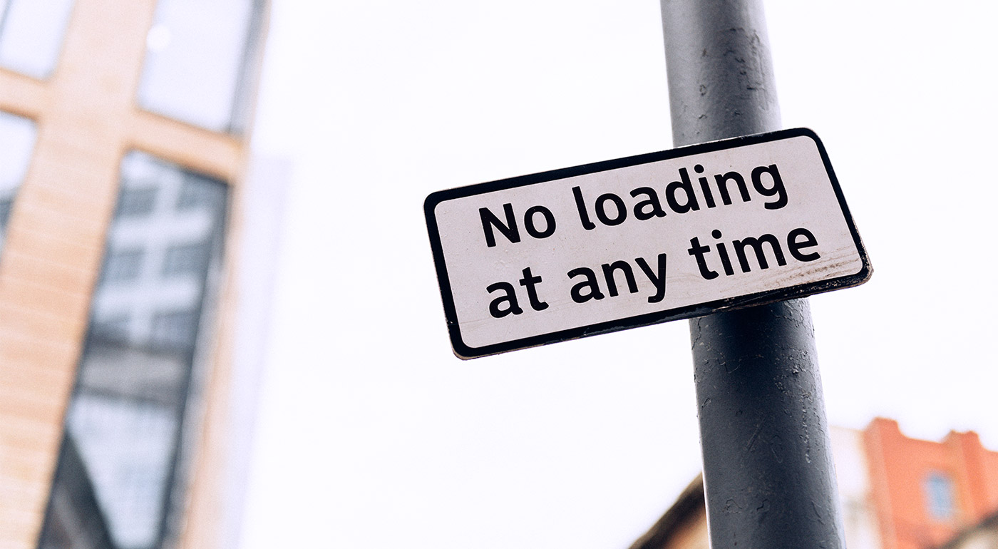 Road sign example: "No loading at any time."