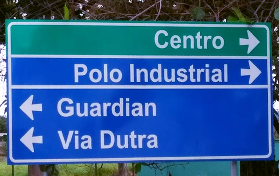 Road Sign set in Arial, with two different background colours: green and blue with text set in white.
